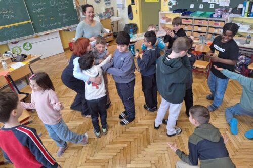 Kinder stehen im Kreis und stellen verschiedene Gefühle dar