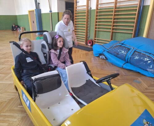 Die Kinder erfahren im Elektroauto warum der Kindersitz so wichtig ist