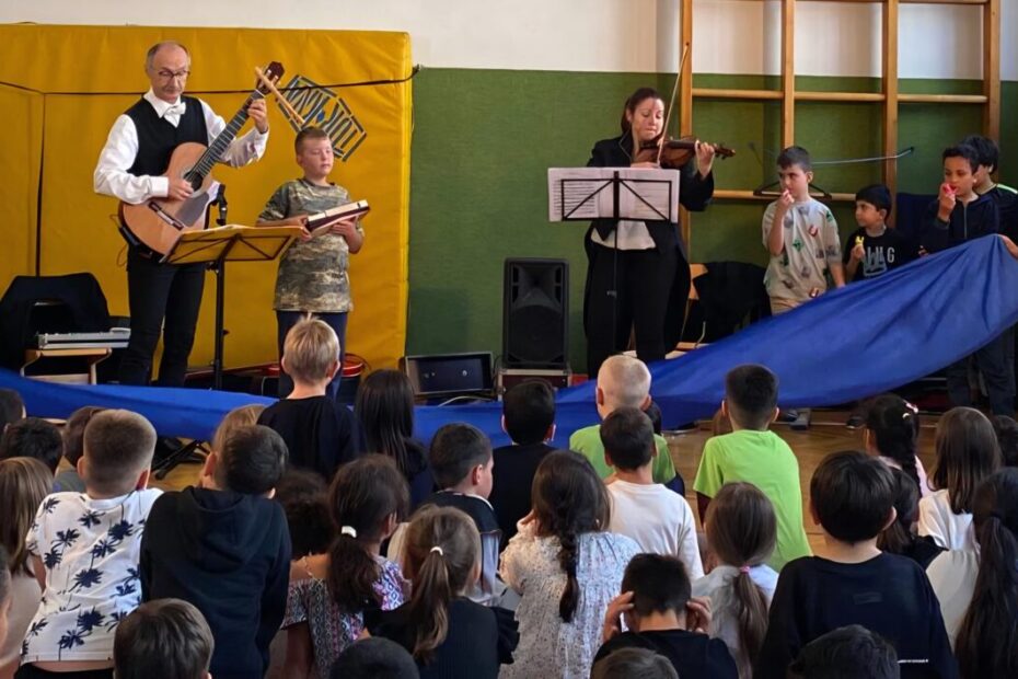 Die Kinder bewegen ein blaues Tuch zu einem Musikstück von Beethoven